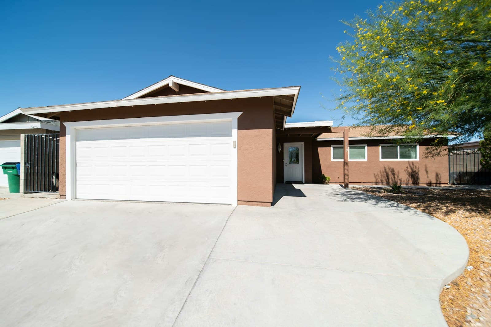 San Antonio home with a clean double garage door and driveway